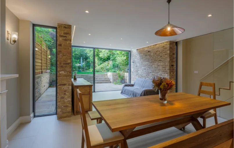 This image depicts the living space from the bench towards the garden. You can see clear glass windows that allow perfect view of the garden, with no obstruction.