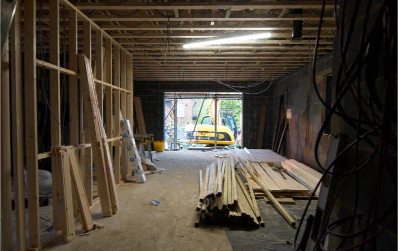 This image depicts the large open plan space on the ground floor of the house with timber studs going up to form some new rooms.