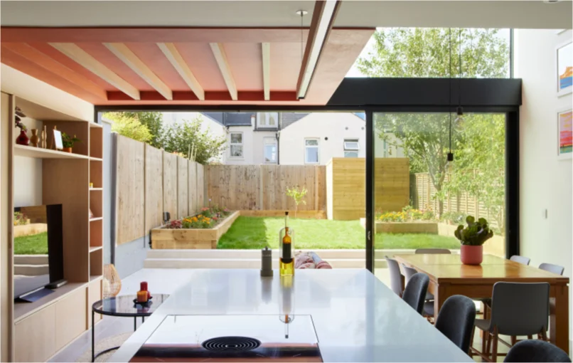 This image depicts the view of the living room from the kitchens island towards the garden.