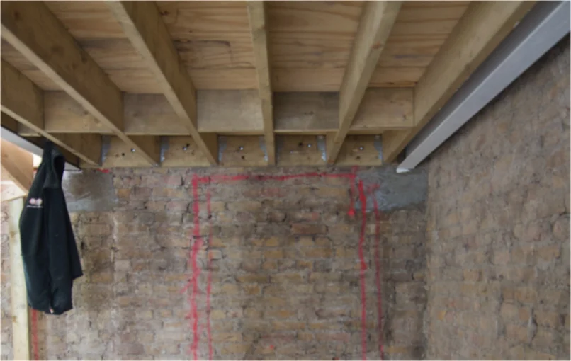 This image depicts a wall from one of the rooms with a red box drawn in the middle showing which part of the wall will be demolished to put in a new window.