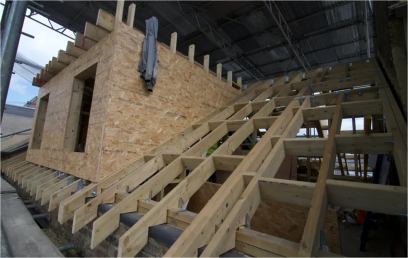 This image depicts the new roof beams of the building with a loft extension.